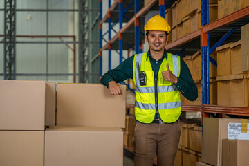 Warehouse worker uses digital tablet for checking stock in a large distribution warehouse.