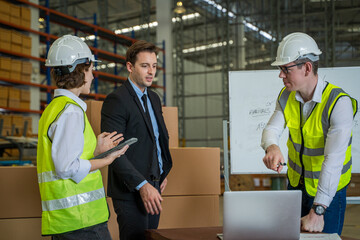 Meeting at warehouse,Warehouse managers with warehouse workers have a briefing in a large distribution center,Concept of teamwork and occupation.