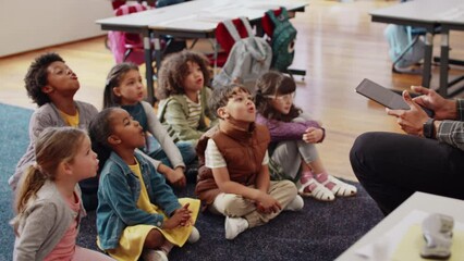 Phonetics lesson in a first grade class: Elementary school children participating in a class activity with their teacher - Powered by Adobe