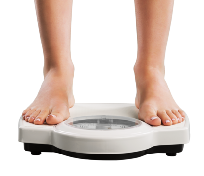 Young woman feet standing on weigh scales,