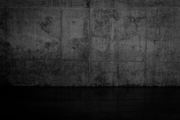 Grungy dark concrete wall and wet floor