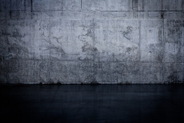 Grungy dark concrete wall and wet floor
