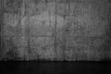 Grungy dark concrete wall and wet floor