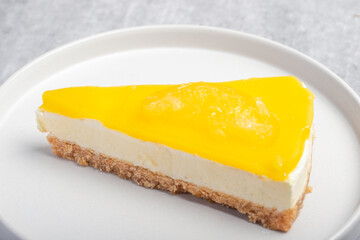 Triangular lemon cheesecake on a white plate