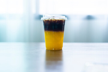 Black coffee mix with orange juice and cold brew Fusion coffee on the  table.