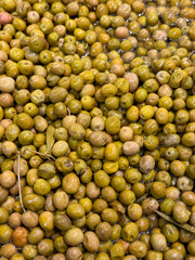 Green olives. Heap of organic olives. Close up. Food background. Top view