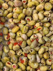 Grilled green olives. Heap of organic olives. Close up. Food background. Top view