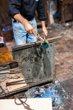 Glass blower at work in workshop in Murano, Italy