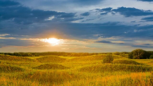 wide summer prairie wit hills at the dramatic sunset  time lapse scene