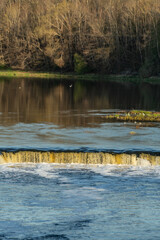 Waterfall in the river on a spring sunny day