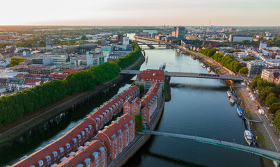 Bremen, Germany. Aerial View on a City of Bremen, Drone flight above the river Weser at sunset time - obrazy, fototapety, plakaty