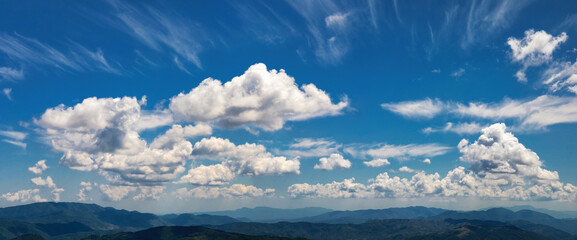 Fototapeta na wymiar Cloudscape. The horizon between heaven and earth is composed of a multitude of clouds above the mountain peaks.