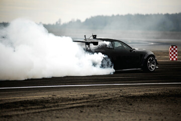Sport car wheel drifting. Blurred of image diffusion race drift car with lots of smoke from burning tires on speed track. Sport concept, Drifting car concept © AvokadoStudio