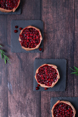 Kalitka pie, Karelian pasty, with cowberry on dark wooden table. Top view - obrazy, fototapety, plakaty