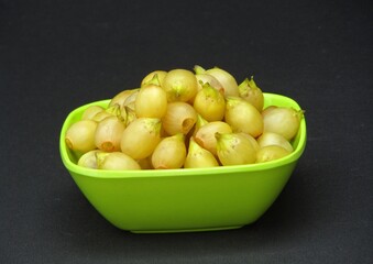 Madhuca longifolia or Mahua in a bowl on black background 