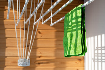 Green towel hanging on a rope on the balcony.