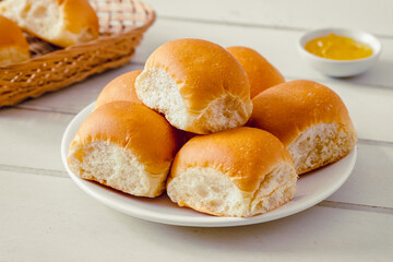 Obraz na płótnie Canvas Soft bread rolls on white plate and jam