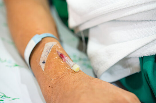 selective focus of patient wrist band tag who lay in white patient bed