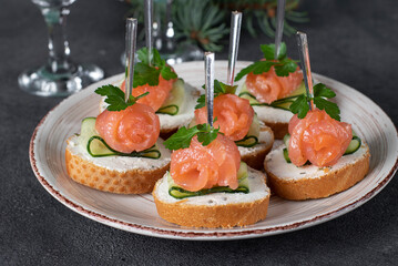 Festive canape with salted salmon, cucumber and soft cheese