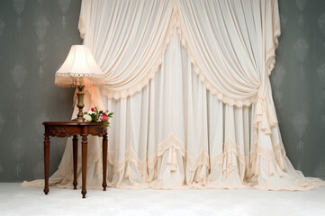 Cream curtains with tassels and ruffles in professional studio shot