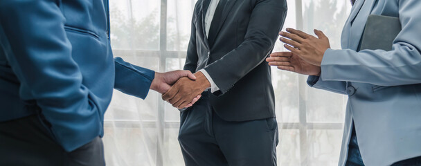 Business handshake for teamwork of business merger and acquisition,successful negotiate,hand shake,two businessman shake hand with partner to celebration partnership and business deal concept.