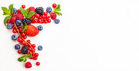 Sweet summer harvest of ripe berries on white background. Top view, copy space.