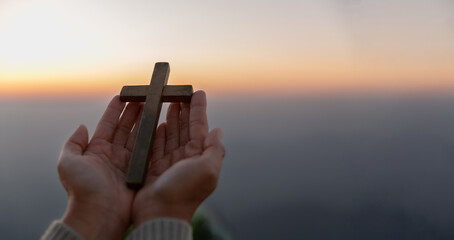 Person hands palm up praying and worship of cross with Belief in Jesus Christ. Eucharist therapy...