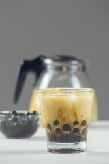 Boba milk tea with ice on white table.has a sweet and refreshing taste