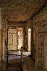 Fototapeta na wymiar Abandoned hallway with paint flaking off the walls