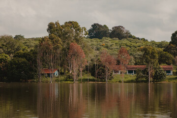 Fototapeta na wymiar lake house among autumn trees