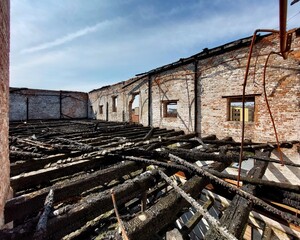 Fototapeta premium On top of a burnt warehouse with multiple storeys