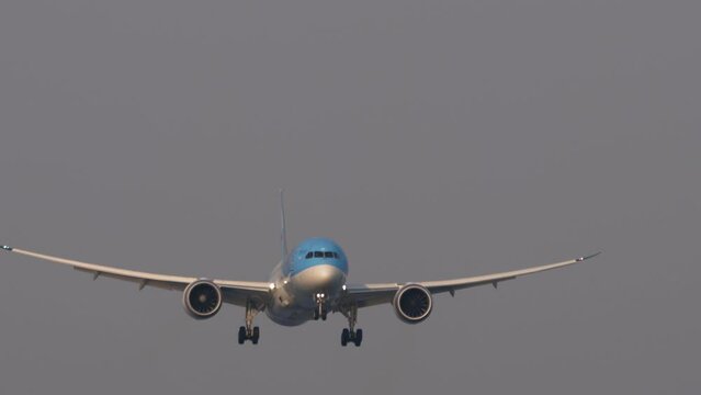 Wide body airliner approaching before landing at Phuket airport. Passenger flight arriving. Airplane flies. Tourism and travel concept