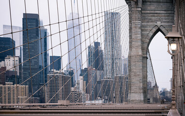 New York city skyline behind Brooklyn Bridge 