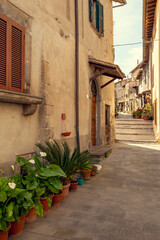 Fototapeta na wymiar Narrow street in Marta town, Tuscany, Italy