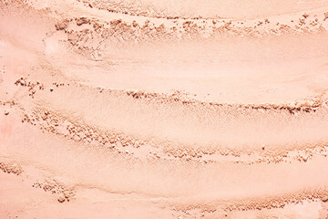 Bronzer or blusher and compact powder  brown nude smudge textured background