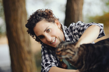 Cats and caresses in the woods with woman.