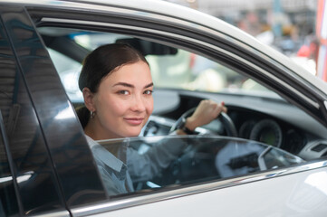 A young beautiful woman driving her car