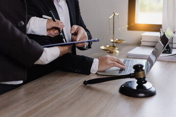 Close-up of asian lawyer and client discussing at office desk, law and justice concept. 