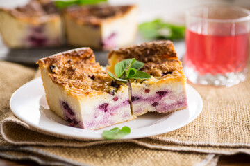 cooked cottage cheese casserole with berry filling in a plate