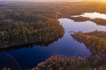 Naklejka na ściany i meble Drone aerial landscape photo - lakes with blue sky reflections and forest in Poland, sunset time, national park