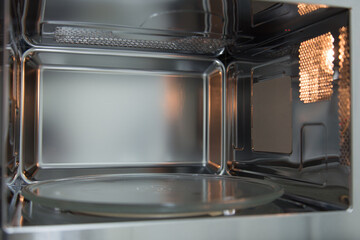 opened microwave inside oven close-up 