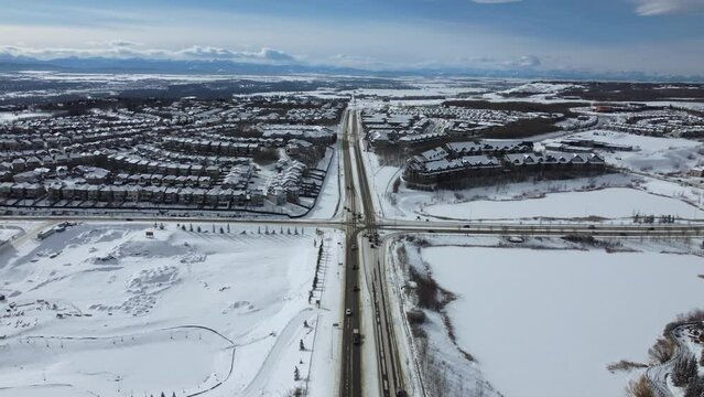 Aerial view of suburban Calgary in winter - looking towards the mountains on the west side. 