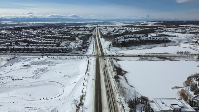 Aerial view of suburban Calgary in winter - looking towards the mountains on the west side. 