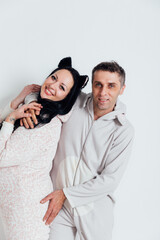 a man and a woman in pajamas in the morning on a white background in the room