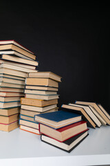 a stack of books in the library on a black background training education science