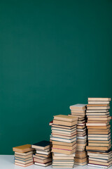 stack of books in the library on a green background training education science