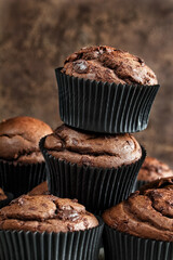 Chocolate muffins. Homemade delicious chocolate cupcake on a dark background close-up, selective focus.