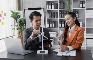 young asian business person team working clean energy business project at desk in office.