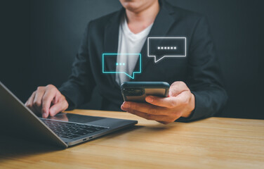 Businessman using smartphone to type, live chat and conversation, social networking concept, doing business, working from home. In the chat box icon appears remind social media marketing technology 