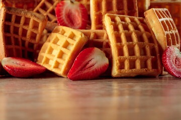 Belgian waffles with strawberries on a beige background.